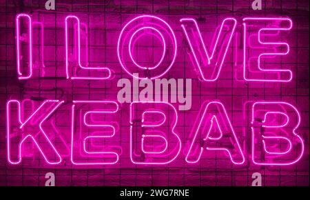 Neon shining sign in pink or purple color on a brick wall with the inscription or slogan I love kebab. Brick wall, background. Bright electric neon li Stock Photo