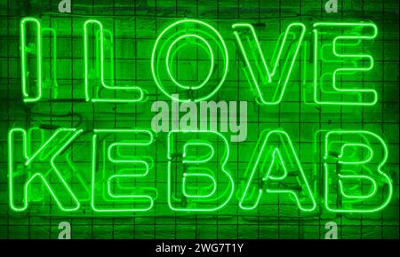 Neon shining sign in green color on a brick wall with the inscription or slogan I love kebab. Brick wall, background. Bright electric neon light. Cafe Stock Photo