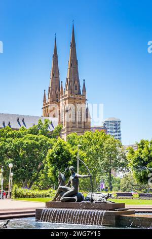 Sydney, Australia – December 26, 2021: Archibald Fountain in front of St Mary’s Cathedral seen from Hyde Park. Stock Photo