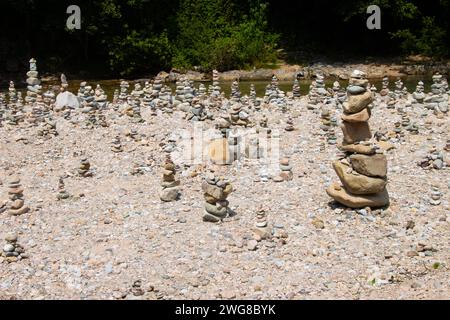Stones piled on top of each other forming towers. Stacks of stones on a river shore in Bihor county, Romania Stock Photo
