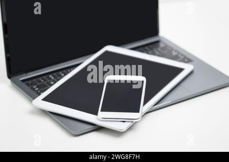 High angle shot of various digital devices on a white table Stock Photo