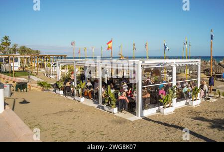 Crowded beach bar restaurant on the beach of Torremolinos,  Costa del Sol, Andalusia, Spain Stock Photo