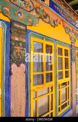 Temples in Tibet are commonly decorated with wood carvings and brightly colored, hand painted walls. Stock Photo