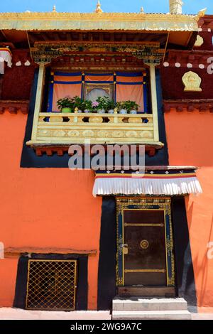 Temples in Tibet are commonly decorated with religious symbols, and wood carvings, often painted with gold trim and walls with bright colors. Stock Photo