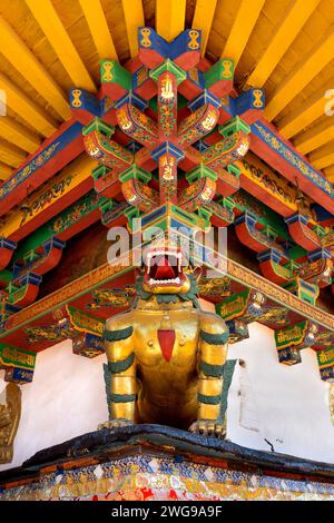 Temples in Tibet are commonly decorated with wood carvings, painted in bright, colorful hues, such as this dragon, or Druk, a symbol of the power of p Stock Photo