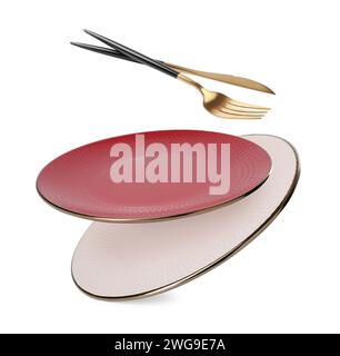 Clean plates, fork and knife falling on white background Stock Photo