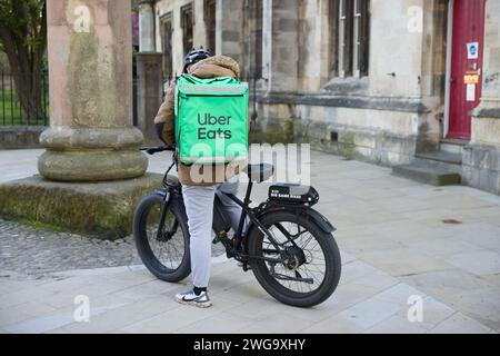 YORK, UK - April 17, 2023. Uber Eats delivery driver on a bicycle, York, UK. Food delivery gig economy. Stock Photo