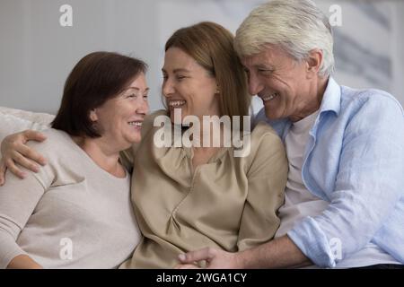 Cheerful older couple of parents and daughter meeting at home Stock Photo