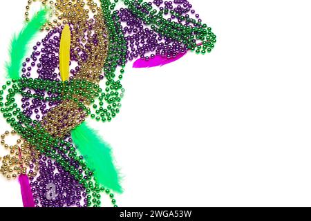 Colorful beads and feathers for Mardi Gras celebration on white background Stock Photo