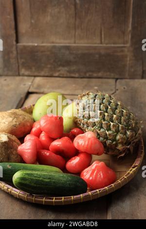 Fresh Fruit Ingredients Making Rujak Lotis or Indonesian Fruit Salad, Sliced Fruit with Spicy Peanut Sauce Stock Photo