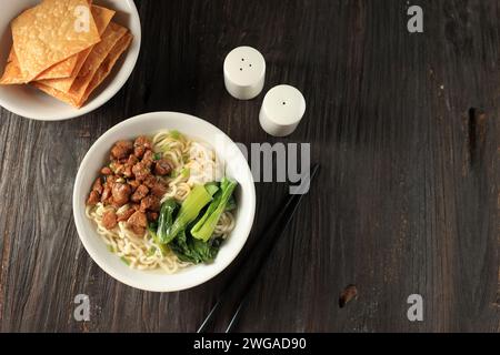 Mie Ayam or Chicken Noodle, Indonesian Popular Street Food with Noodle, Chicken, and Green Vegetables with Broth Stock Photo