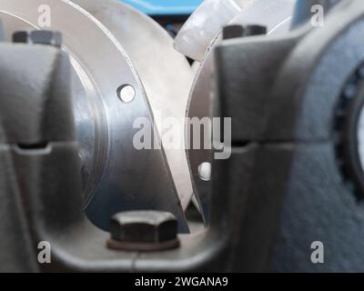 Industrial abstract. Bearing housings and screws of an industrial twin screw press. Very shallow depth of field with the screws in the middle of the p Stock Photo