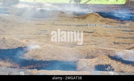 brick burning using dry husks somewhere in Indonesia Stock Photo