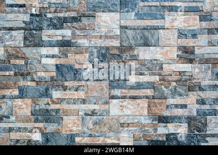 Background from a wall made of small stone tiles Stock Photo