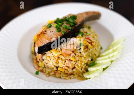 Fried rice with grilled salmon fillet steak on white plate. Stock Photo