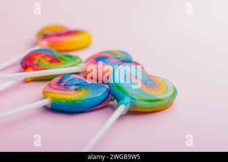 Heart shaped lollipop. Sweet candy on the pink background. Stock Photo