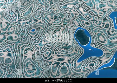 Abstract pattern of water ripples caused by tower block reflections, Canary Wharf, London Stock Photo