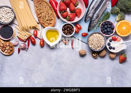 on the textured background, variety of Mediterranean healthy foods based on legumes, fish, vegetables, fruits and grains Stock Photo
