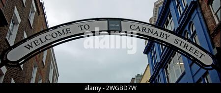 Sign to welcome Shoppers to Carnaby Street, Soho, London, UK Stock Photo