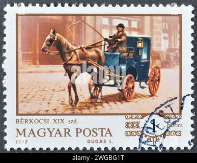 Cancelled postage stamp printed by Hungary, that shows Hackney-carriage, 1890, circa 1977. Stock Photo