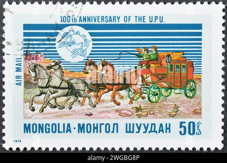 Cancelled postage stamp printed by Mongolia, that shows Mail Coach, Centenary of Universal Postal Union (U.P.U.), circa 1974. Stock Photo