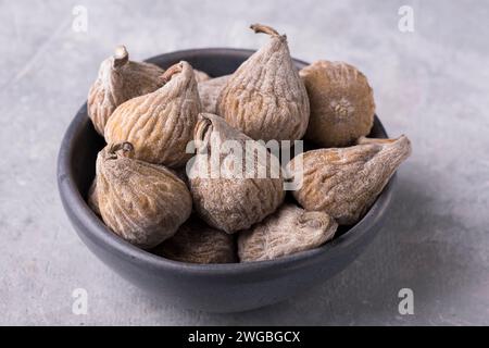 in the foreground, bowl containing dried figs floured with rice flour. Stock Photo