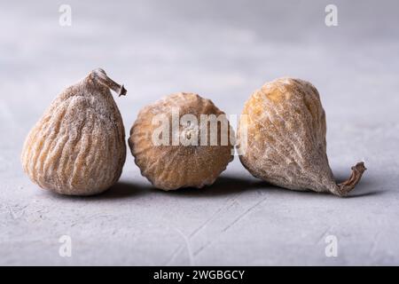 in the foreground three dried figs floured with rice in the foreground three dried figs floured with rice flour. Stock Photo