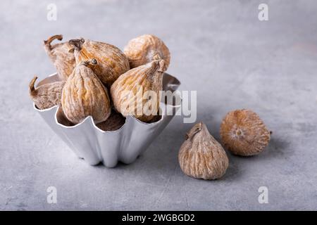 in the foreground, a cake tin containing dried figs floured with rice flour. Stock Photo