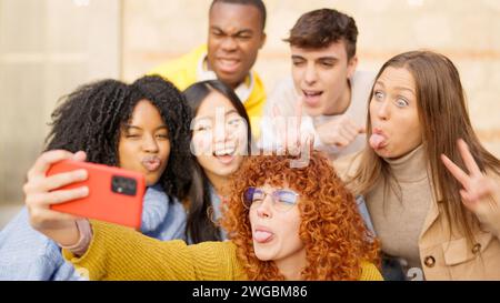 Multiethnic friends having fun on the street taking a selfie Stock Photo