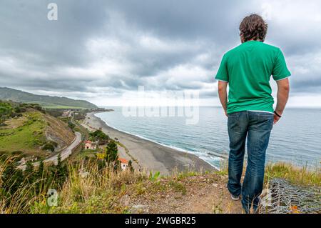 Man scans the horizon from the top of a sanctuary Stock Photo