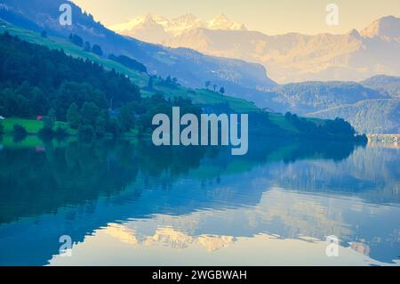 Mountain reflections in Lake Lungern on a misty day, Obwalden, Switzerland Stock Photo