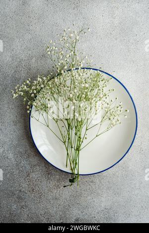 Overhead view of White gypsophila flowers on a plate Stock Photo