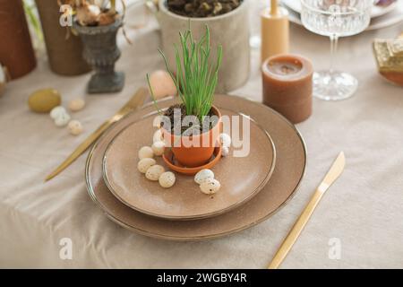 Close-up of festive Easter place setting with Easter eggs, spring flowers and candles Stock Photo