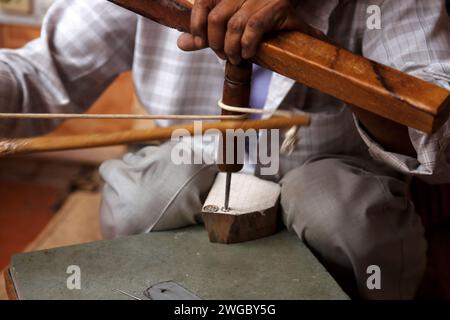 Close-up of a man making wooden blocks for textile hand printing, Rajasthan, India Stock Photo