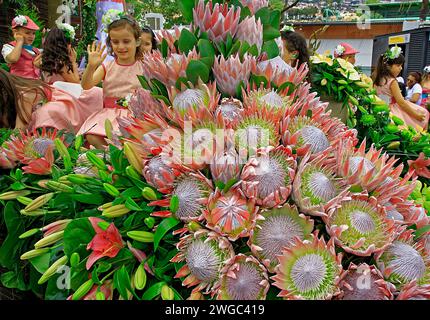 Flower float, flower decoration, Proteas (Protea cynaroides) children, flower festival, Funchal, Madeira Island Stock Photo