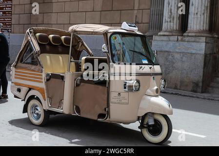 Palermo, Italy - May 13, 2023: Tricycle of the Piaggio brand that make tourist circuits parked on a street in the old town of Palermo, Sicily, Italy Stock Photo