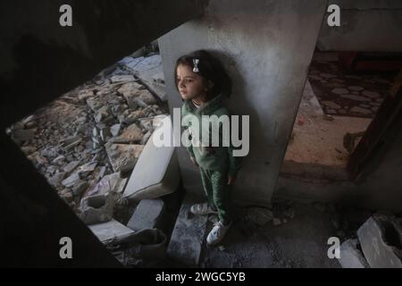 Beijing, China. 3rd Feb, 2024. A Palestinian girl checks the debris of a building after Israeli airstrikes in the southern Gaza Strip city of Rafah, Feb. 3, 2024. In the early hours of Saturday, at least 24 Palestinians, including children and women, were killed as Israeli airstrikes and artillery bombardments struck houses in the Gazan cities of Deir al-Balah and Rafah, according to the official Palestinian news agency WAFA. Credit: Khaled Omar/Xinhua/Alamy Live News Stock Photo