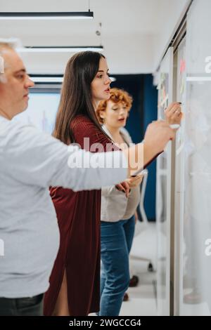 Multiracial colleagues brainstorm for business expansion and profit growth in a pleasant office atmosphere. Stock Photo