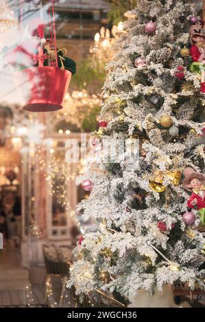Snowflake on pine tree with glitter balls and dolls decoration in christmas festival Stock Photo