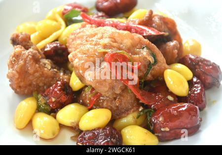 deep fried slice mango fish with yellow ginkgo and pickled jujube couple black mushroom in sweet sour sauce on plate Stock Photo