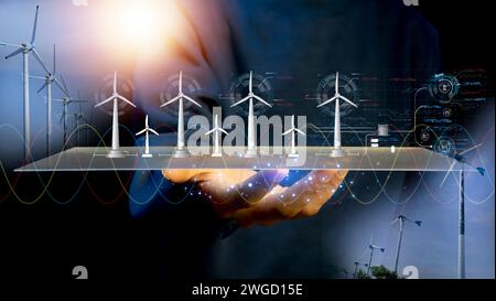 Technology for the environment Using environmentally friendly technology Engineer designs wind turbine models clean energy network Stock Photo