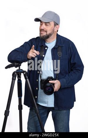 Male photographer posing with modern digital SLR camera and tripod isolated on white background Stock Photo