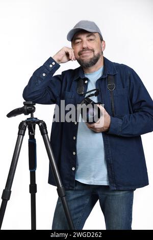 Male photographer posing with modern digital SLR camera and tripod isolated on white background Stock Photo