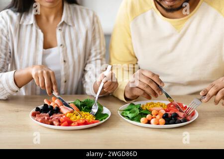 Cropped of couple sitting at table, eating breakfast Stock Photo