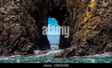 Natural arch in cliffs, Bruny Island Stock Photo