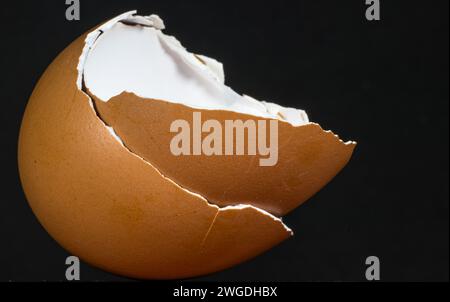 Cracked egg with a hole in its shell Stock Photo