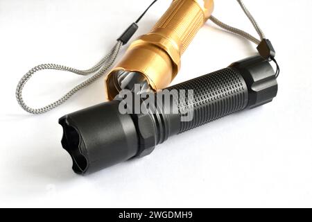 Black and golden colored hand-held lanterns lie on the table. Stock Photo
