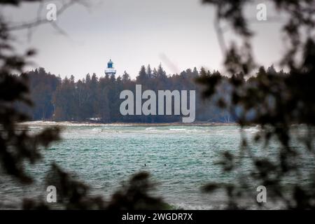 Glancing through the trees at the Cana Island Lighthouse in Baileys Harbor, Wisconsin. Stock Photo