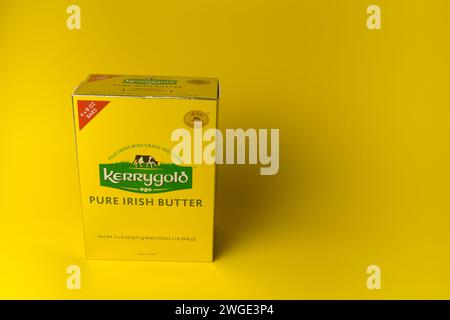 Packs of  Kerrygold Irish butter imported into the USA on a yellow background Stock Photo