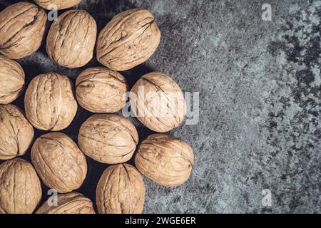 Whole walnuts in shells on dark background. Fresh organic nuts. Top overhead view. Whole walnuts in shells on dark background. Fresh organic nuts. Top Stock Photo